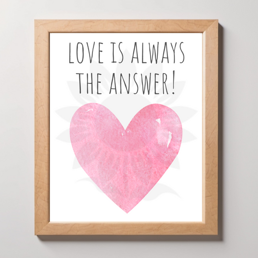 Framed wall art featuring a soft pink heart with the text 'LOVE IS ALWAYS THE ANSWER!' The design is from Blossoming Minds, promoting love, compassion, and positivity for children.