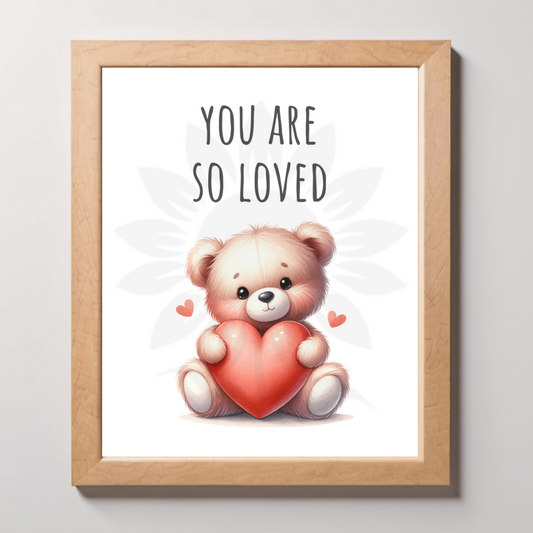 Mockup wall art featuring a cute teddy bear holding a heart with the text 'YOU ARE SO LOVED' above it. The design is from Blossoming Minds, promoting self-love and positivity for children.