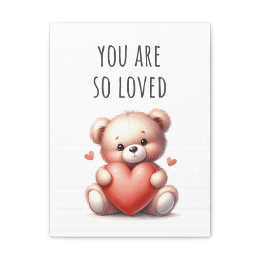 Framed canvas print of a teddy bear holding a heart with the text 'You are so loved.'